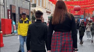 Tall girl walking through Chinatown becomes the center of everyone's universe