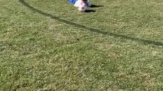 Little Boy Stumbles and Falls While Kicking Soccer Ball