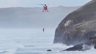 Video shows dramatic rescue after dog walker falls into the sea