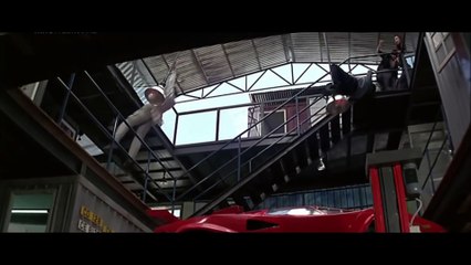 Jackie Chan fights with Cougar's thugs in an auto repair shop in the movie THUNDERBOLT (1995)