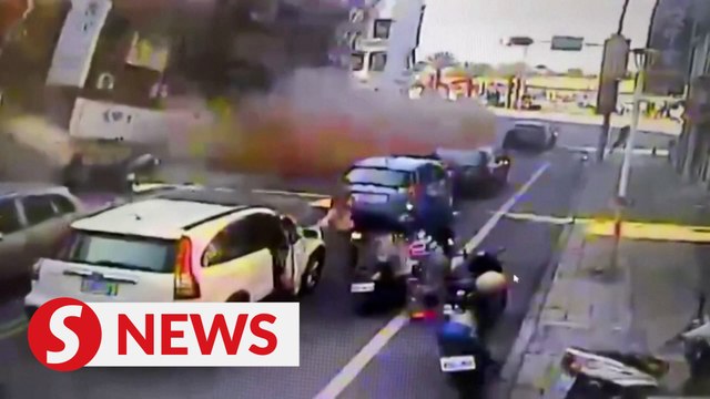 MOMENT: Building collapses on busy street as powerful quake hits Taiwan