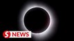 Canadians cheer as solar eclipse darkens sky