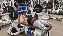 Female bench presses 225lbs for reps