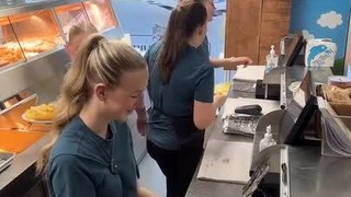 Girl Spills Sauce While Readying Meal at Restaurant