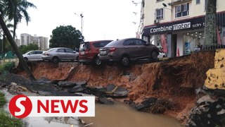 Cars stuck in road slip in Selayang due to heavy morning downpour