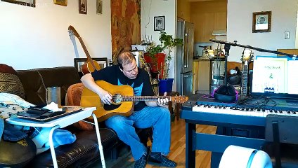 PLAYING ACCOUSTIC GUITAR  ON NORMAN B-20, TUNED IN OPEN A.