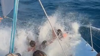 Women Sitting on Catamaran Net Gets Soaked by Tall Waves