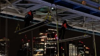 Cleaners dangle 33m from Tower Bridge as underside glass cleaned for first time in decade