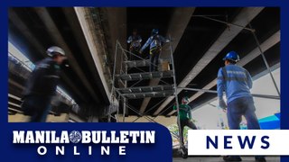 DPWH workers set up scaffolding under Kamuning-EDSA flyover