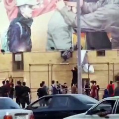 People of Iran are tearing banners showing anger over the rule of former General Qasim Suleimani