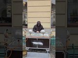 Man Plays Music with Crystal Glass on Street
