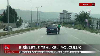 Hatay'da otomobile tutunarak giden bisikletlinin tehlikeli yolculuğu