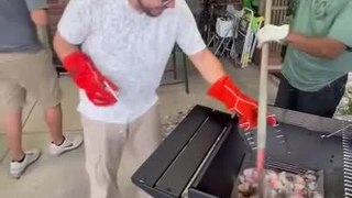 Guys Transfer Hot Charcoal From Old Barbecue to New One