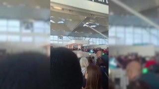 Passengers queue at Standted Airport due to power outage