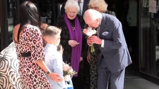 King and Queen exchange flowers and presents with children as Charles resumes public duties