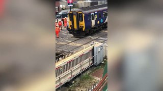 Car crushed by train at crossing gets removed