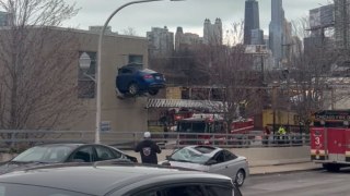 Filming of TV show stunt shows car sticking halfway out of a building