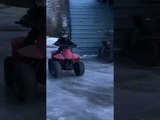 Young Boy Rides ATV on Ice Covered Yard