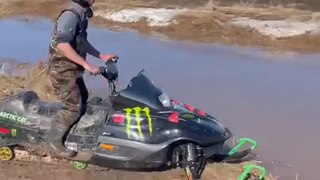 Man Falls Into Water While Trying to Ride Snowmobile on It