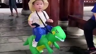 Funny Cute Baby Riding On Dinosaur