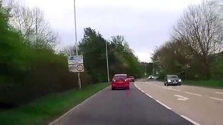 Deer runs across busy main road causing car to swerve