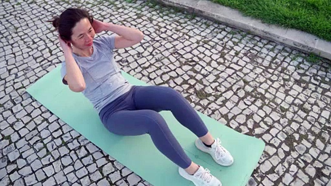 Doing Ab Crunches on Yoga Mat Outdoors