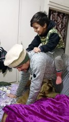 baby riding his father back