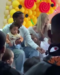 Rihanna tries to hold her son, Rza, during his birthday party