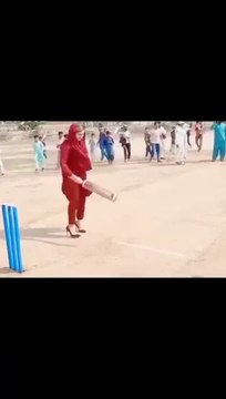 Girl playing cricket with boys