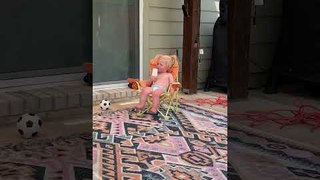 Toddler Enjoys Popsicle Sitting on Deck Chair