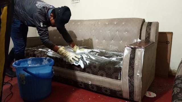 Cleaning Sofa with hands