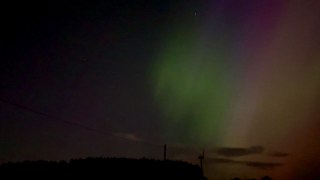 Aurora Borealis shines bright over Whitelee Windfarm during magical solar storm