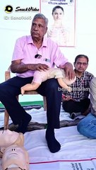 This old man spreading his skills how to save kids if something's stuck there throats