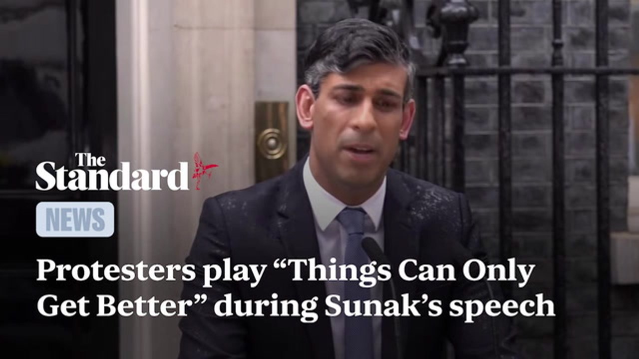 Protesters play "Things Can Only Get Better" during Sunak's speech