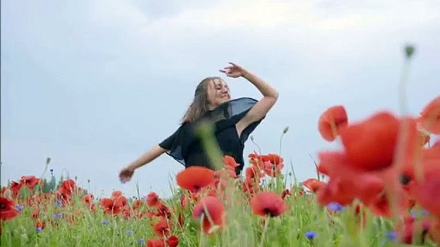 A girl dancing happily in the flowers