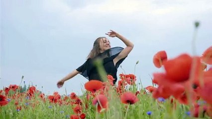 A girl dancing happily in the flowers