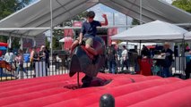 Riding the Mechanical bull at the Cloverdale Rodeo and Country fair, BC, Canada