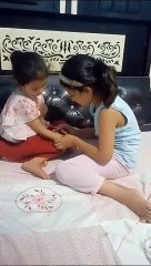 Akshu putting mehendi on Trishu hand-may24