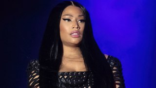 Nicki Minaj greeted her fans on the balcony of her hotel room after she was forced to postpone her gig in Manchester