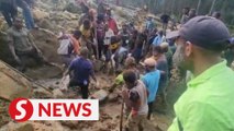 With bare hands and sticks, locals search for survivors in deadly PNG landslide