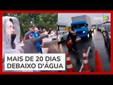 Moradores atiram água de enchente em rodovia durante manifestação em Porto Alegre