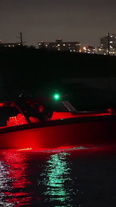 Midnight Express Power Boat with all controls visible in the dark at the Haulover Inlet in Miami, Florida
