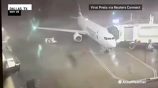 Parked airplane blown away by storm winds at Dallas airport