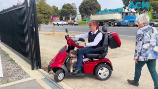 Cootamundra veteran Karen Doyle and her support dog Caly test out mobility scooters in Wagga