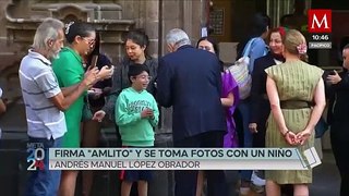 AMLO firma 'amlito' a un niño y se toma fotos con él