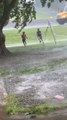 Children Runs to Their House in Rain Through Flooded Yard in Kentucky, USA