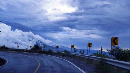mixkit-going-down-a-curved-highway-through-a-mountain-range-41576-medium