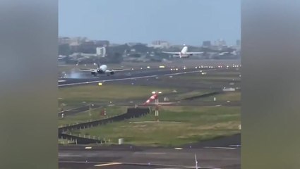 Plane lands on runway as another jet takes off at same time