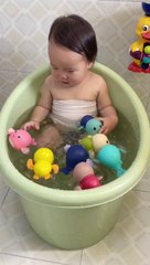 Cute baby playing with ducks