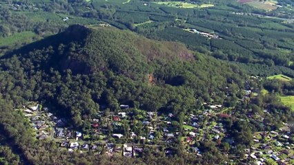 Two men charged after body found north of Brisbane